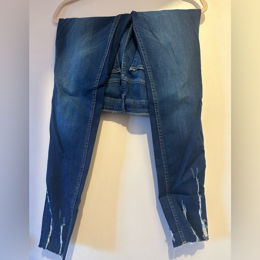 Women's denim jeans with distress marks